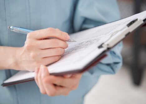 Man with clipboard writing notes